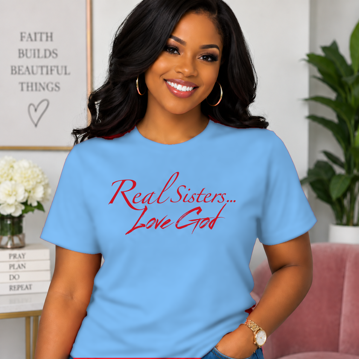 Model wearing Carolina Blue Real Sisters Love God T-shirt with Red lettering, crisp original logo
