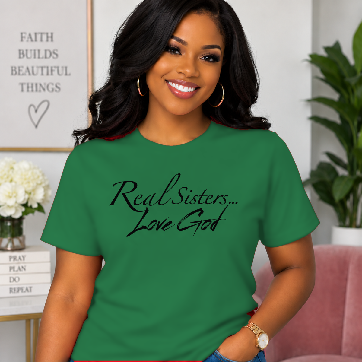 Model wearing Green Real Sisters Love God T-shirt with Black lettering, crisp original logo