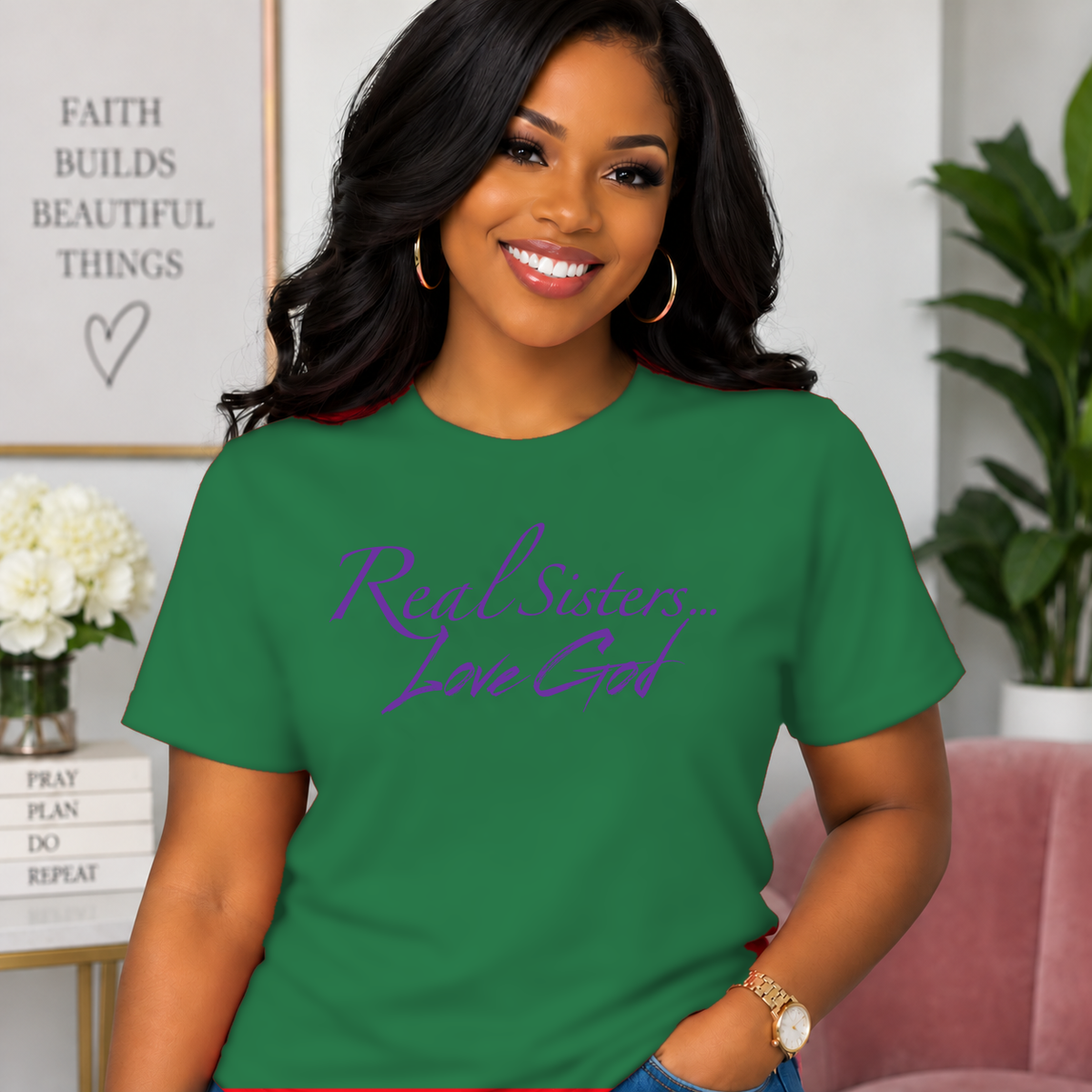 Model wearing Green Real Sisters Love God T-shirt with Purple lettering, crisp original logo
