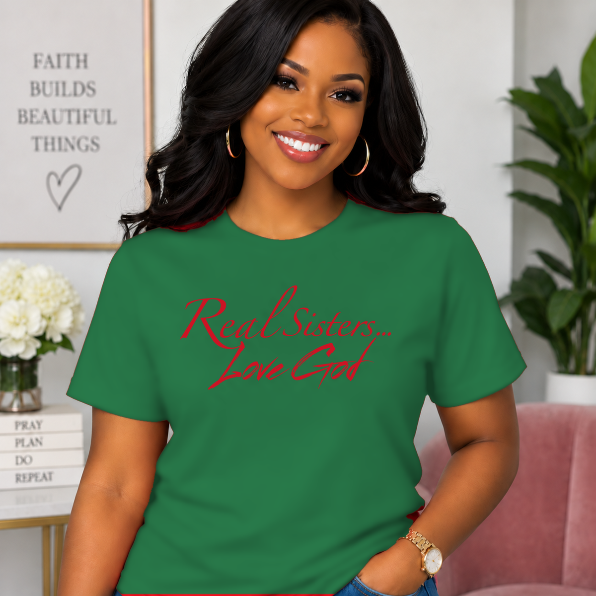 Model wearing Green Real Sisters Love God T-shirt with Red lettering, crisp original logo
