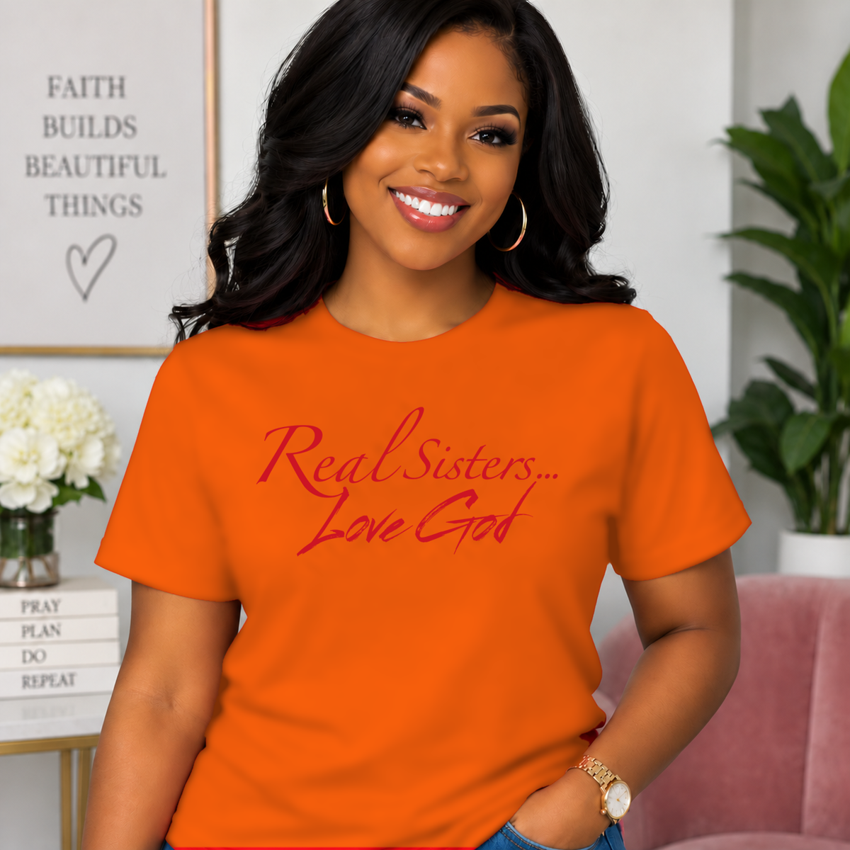 Model wearing Orange Real Sisters Love God T-shirt with Red lettering, crisp original logo