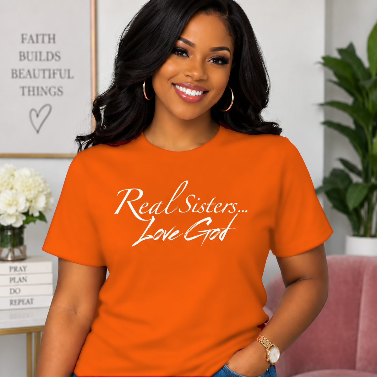 Model wearing Orange Real Sisters Love God T-shirt with White lettering, crisp original logo