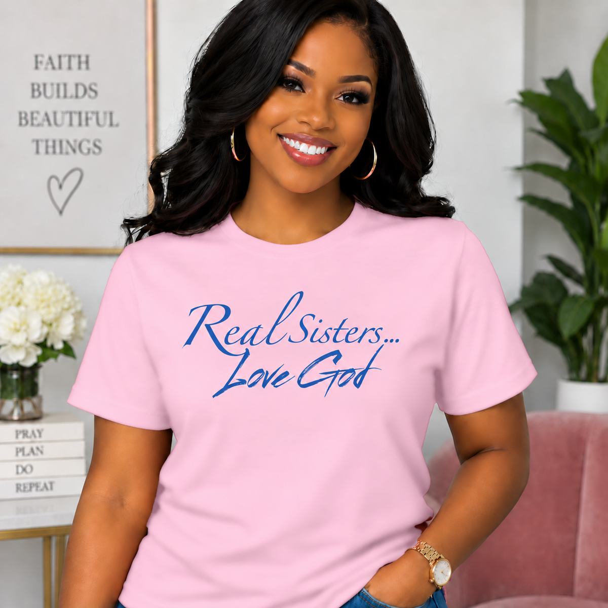Model wearing Light Pink Real Sisters Love God T-shirt with Blue lettering, crisp original logo
