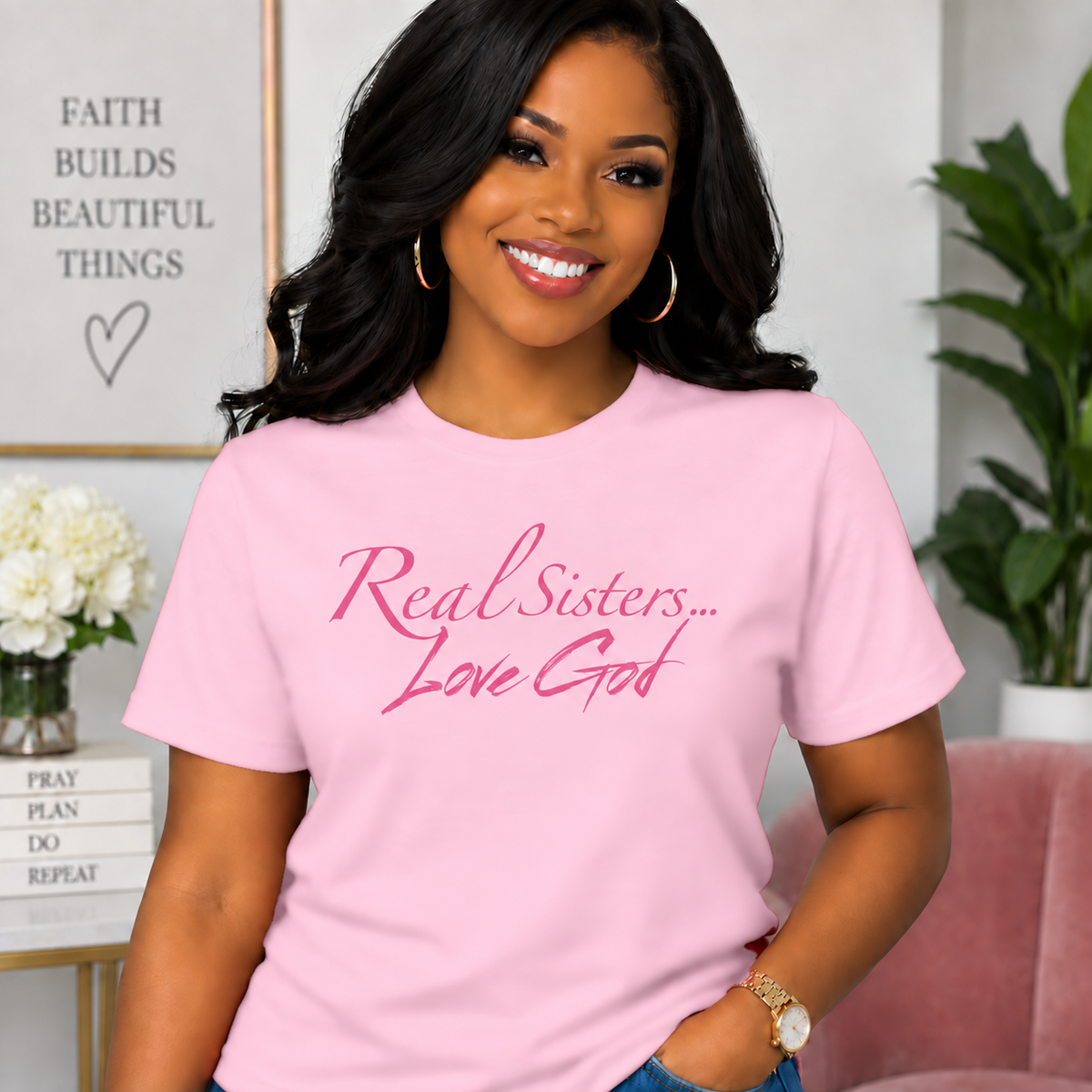 Model wearing Light Pink Real Sisters Love God T-shirt with Pink lettering, crisp original logo