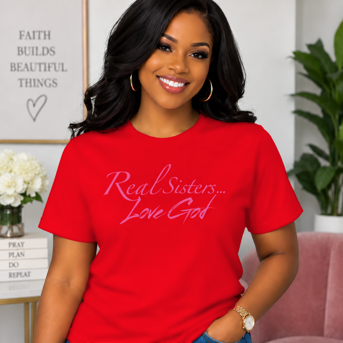 Model wearing Red Real Sisters Love God T-shirt with Pink lettering, crisp original logo